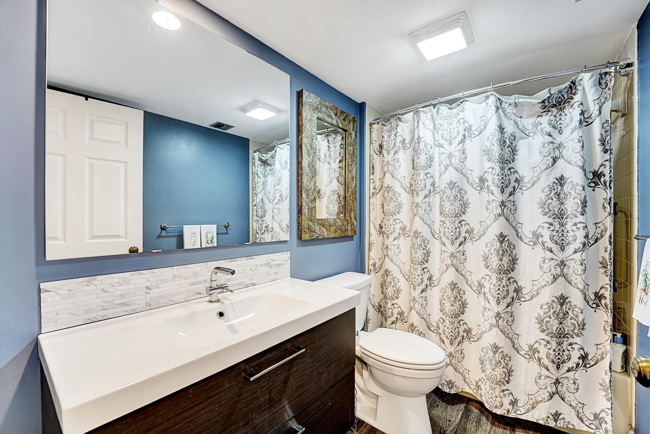 6097 Balboa Circle, Unit 406 Boca Raton, FL 33433 - Photo 16 of 28 a bathroom with a sink toilet and shower