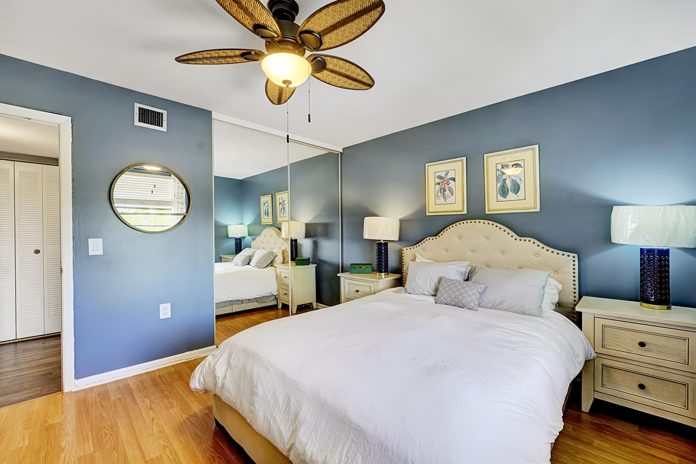 6097 Balboa Circle, Unit 406 Boca Raton, FL 33433 - Photo 18 of 28 a bedroom with a bed and a chandelier