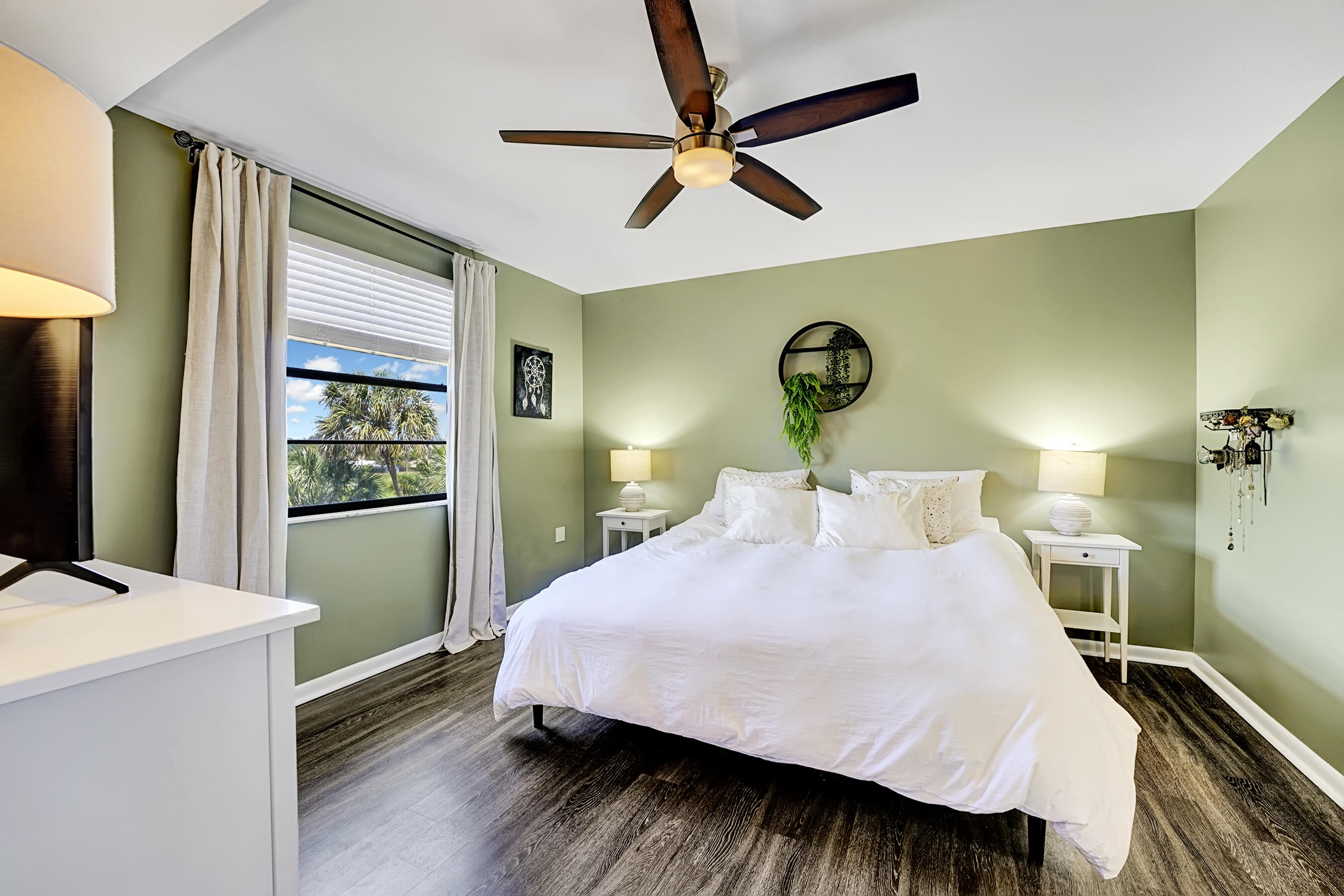 6097 Balboa Circle, Unit 406 Boca Raton, FL 33433 - Photo 19 of 28 a bedroom with a bed and a flat tv screen on dresser