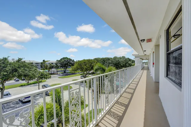 a view of balcony with wooden floor and fence