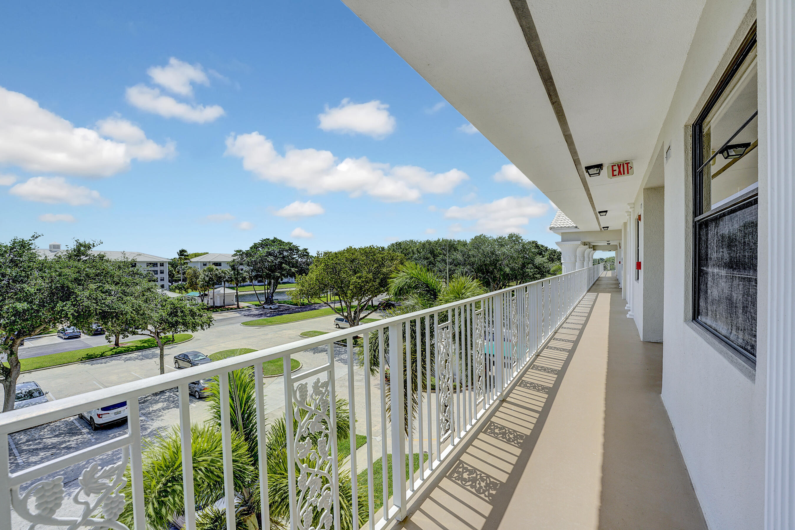 6097 Balboa Circle, Unit 406 Boca Raton, FL 33433 - Photo 2 of 28 a view of balcony with wooden floor and fence