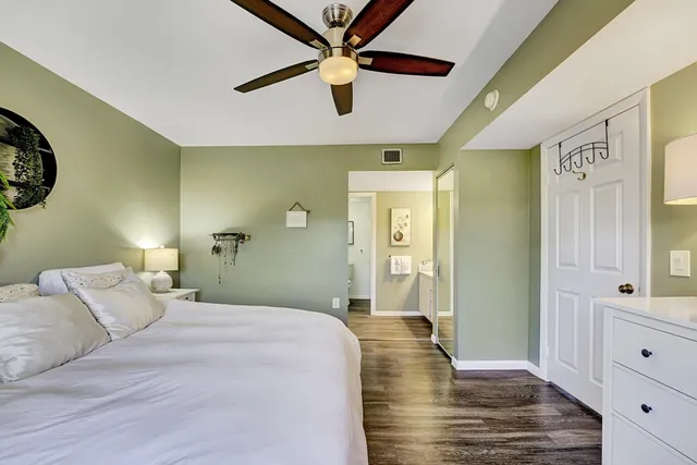 a bedroom with a bed and a view of closet
