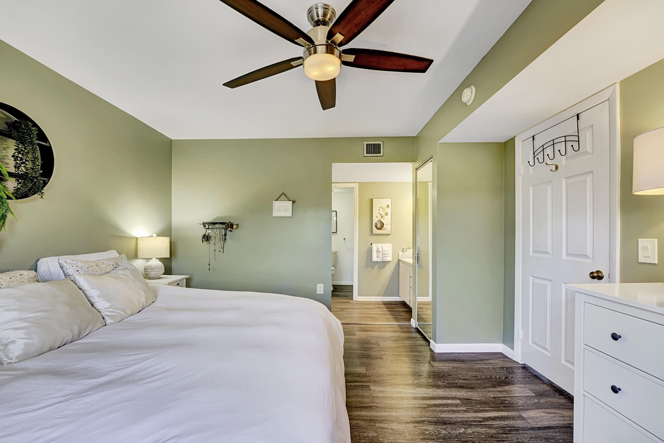 6097 Balboa Circle, Unit 406 Boca Raton, FL 33433 - Photo 21 of 28 a bedroom with a bed and a view of closet