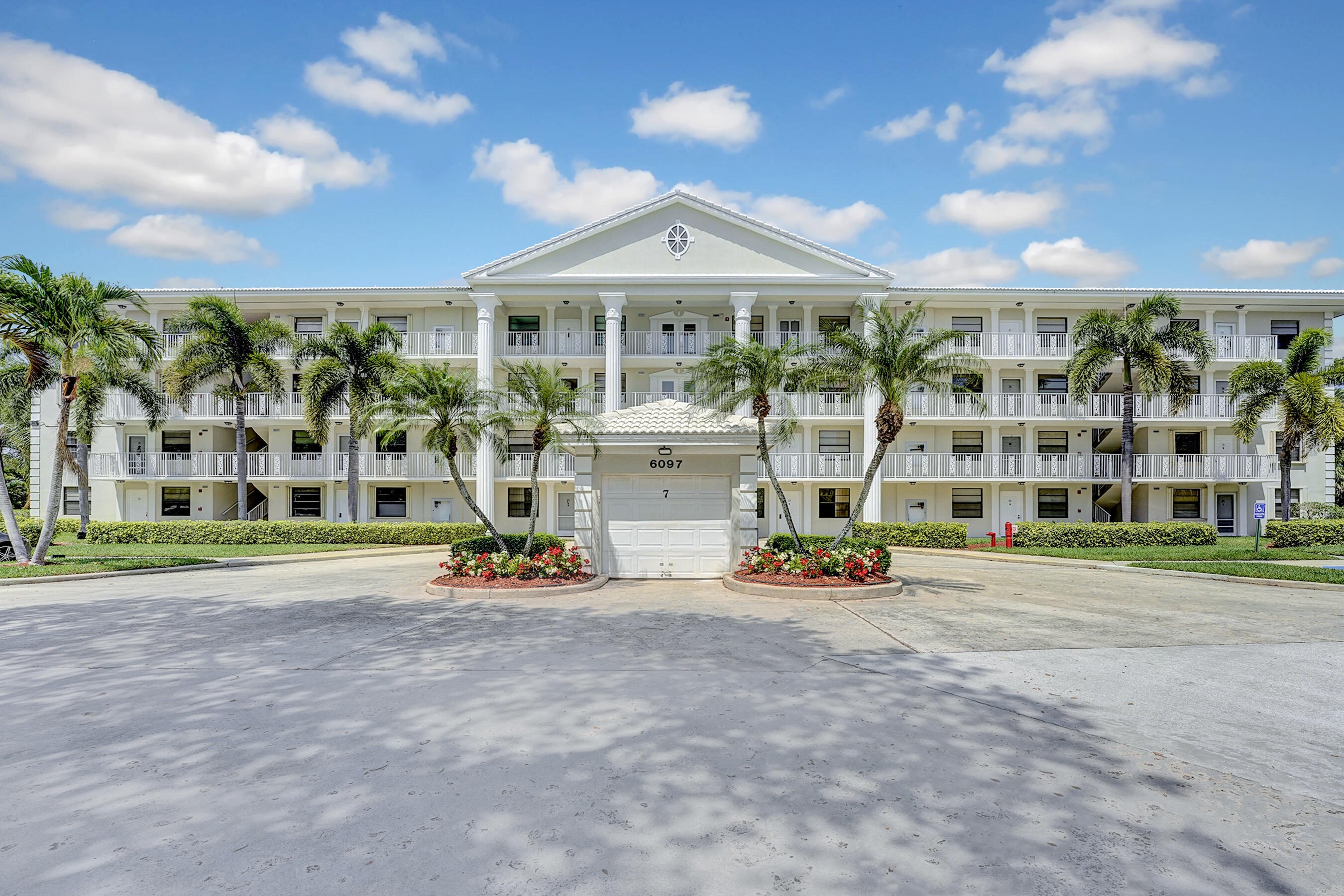 6097 Balboa Circle, Unit 406 Boca Raton, FL 33433 - Photo 26 of 28 a front view of a building with street view