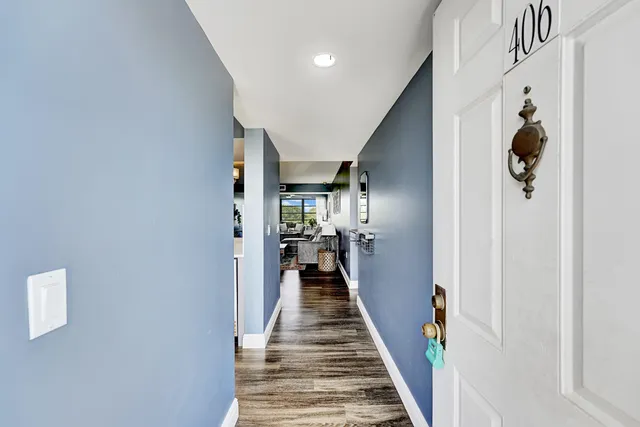 a view of a hallway with wooden floor and closet