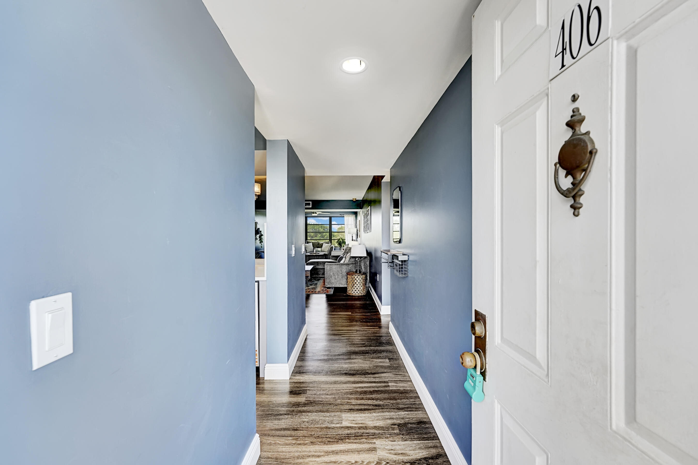 6097 Balboa Circle, Unit 406 Boca Raton, FL 33433 - Photo 3 of 28 a view of a hallway with wooden floor and closet