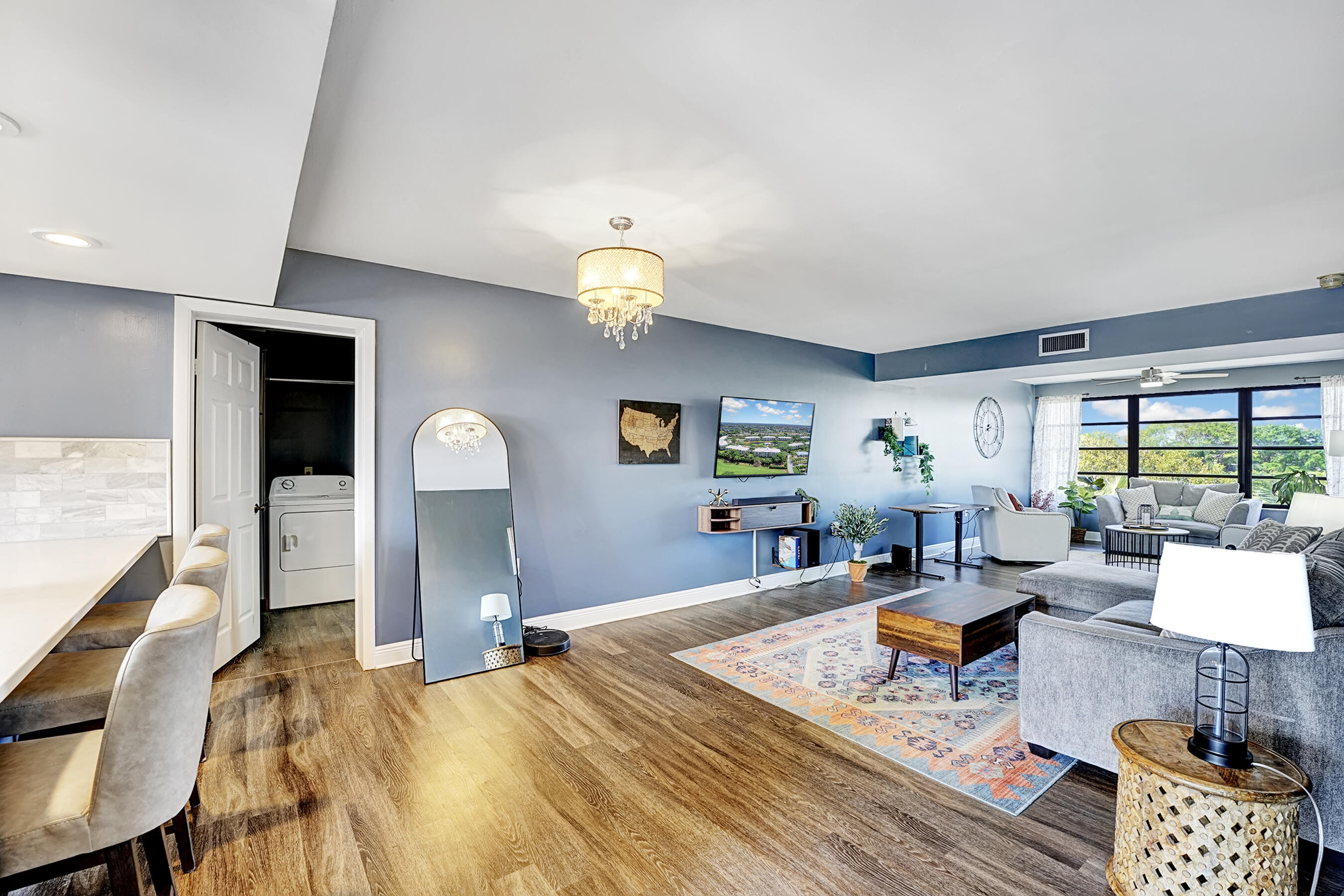 6097 Balboa Circle, Unit 406 Boca Raton, FL 33433 - Photo 4 of 28 a living room with furniture and a large window