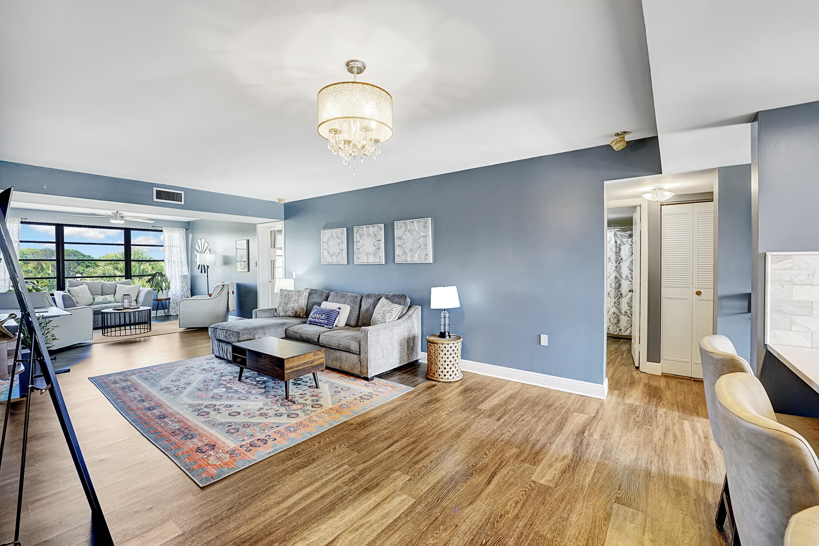 6097 Balboa Circle, Unit 406 Boca Raton, FL 33433 - Photo 5 of 28 a living room with furniture and a wooden floor