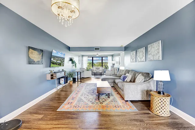 a living room with furniture wooden floor and a table