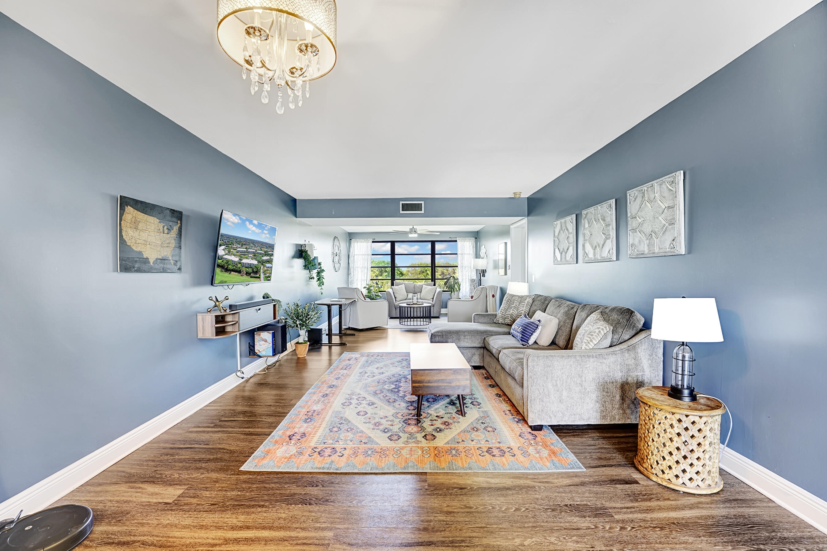 6097 Balboa Circle, Unit 406 Boca Raton, FL 33433 - Photo 6 of 28 a living room with furniture wooden floor and a table