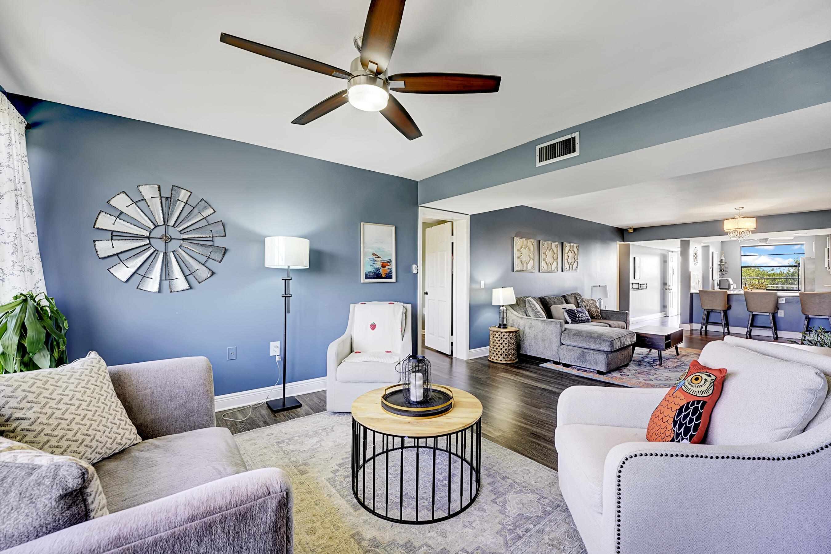 6097 Balboa Circle, Unit 406 Boca Raton, FL 33433 - Photo 9 of 28 a living room with furniture a chandelier and a window