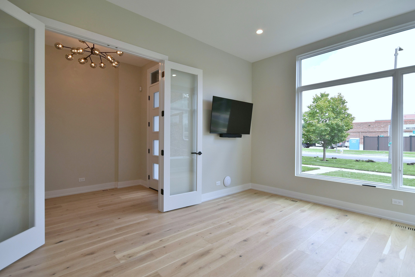 274 North Addison Avenue Elmhurst, IL 60126 - Photo 15 of 57 a view of an empty room with a window and wooden floor