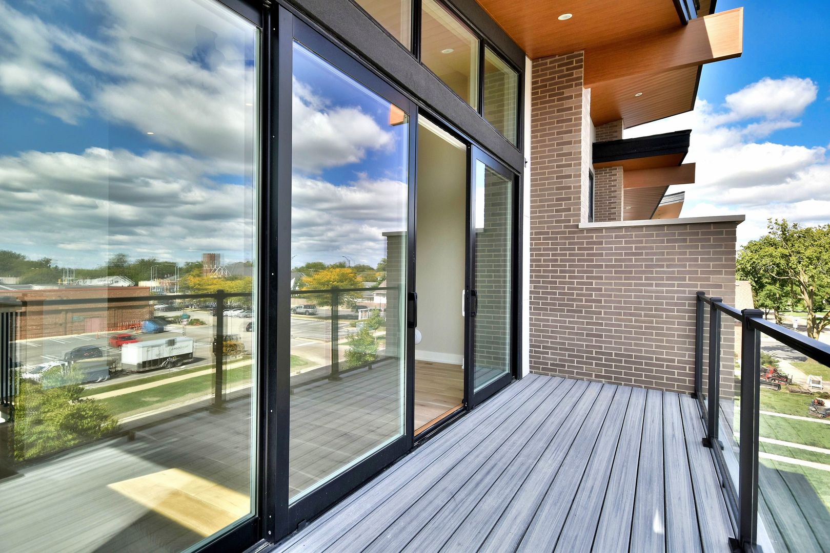 274 North Addison Avenue Elmhurst, IL 60126 - Photo 41 of 57 a view of a balcony with floor to ceiling windows with wooden floor