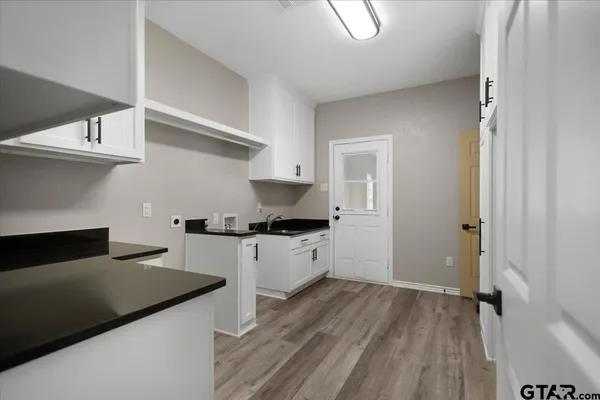 a kitchen with a stove and white cabinets