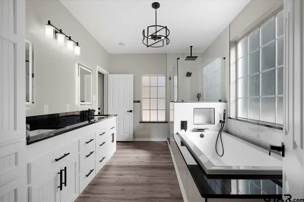 a large white kitchen with a large window