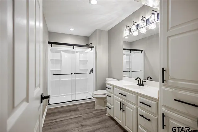 a bathroom with a double vanity sink mirror and shower
