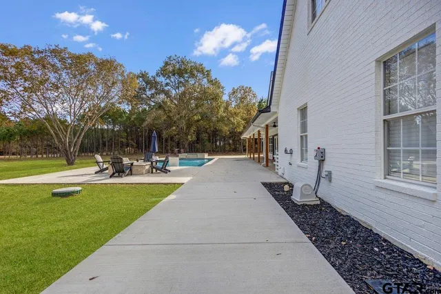 a view of a house with swimming pool and sitting area