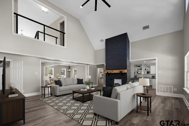 a living room with fireplace furniture and a wooden floor