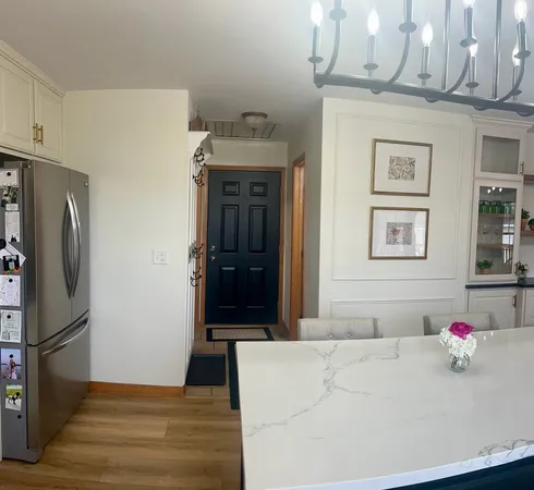 a bedroom with a bed and a refrigerator