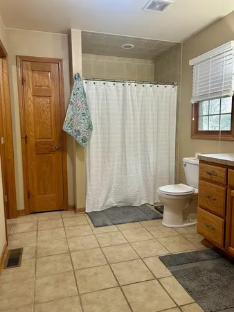 a bathroom with a toilet and a shower
