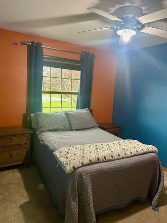 a bed sitting in a bedroom next to a window