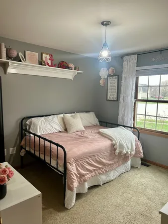 a bedroom with a bed and a chandelier