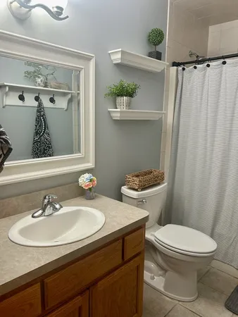 a bathroom with a sink mirror and toilet