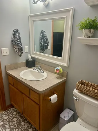 a bathroom with a sink toilet and a mirror