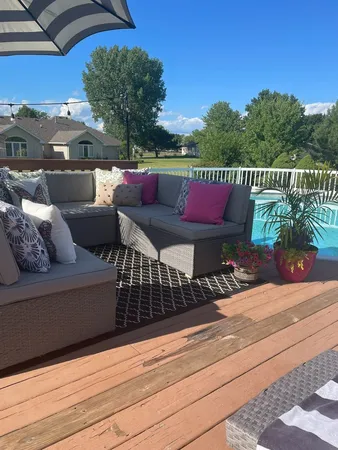 a roof deck with couches and wooden floor