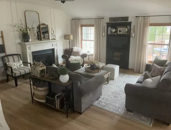 a living room with furniture and a fireplace