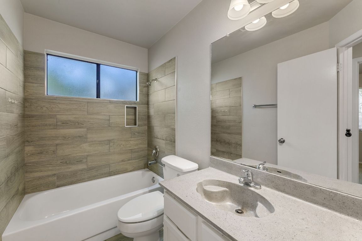 1808 Prairie Star Lane Round Rock, TX 78664 - Photo 16 of 32 a bathroom with a sink a toilet and shower