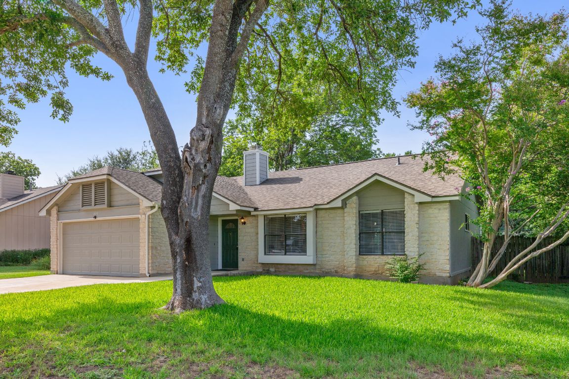 1808 Prairie Star Lane Round Rock, TX 78664 - Photo 2 of 32 a front view of a house with a garden and yard