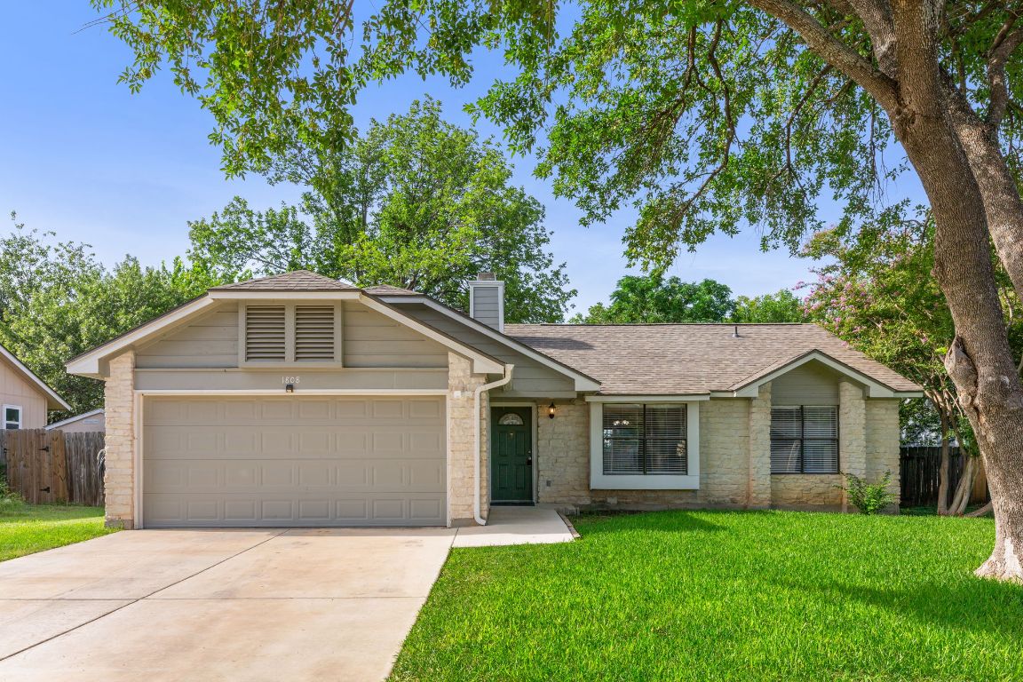 1808 Prairie Star Lane Round Rock, TX 78664 - Photo 3 of 32 a front view of a house with a garden