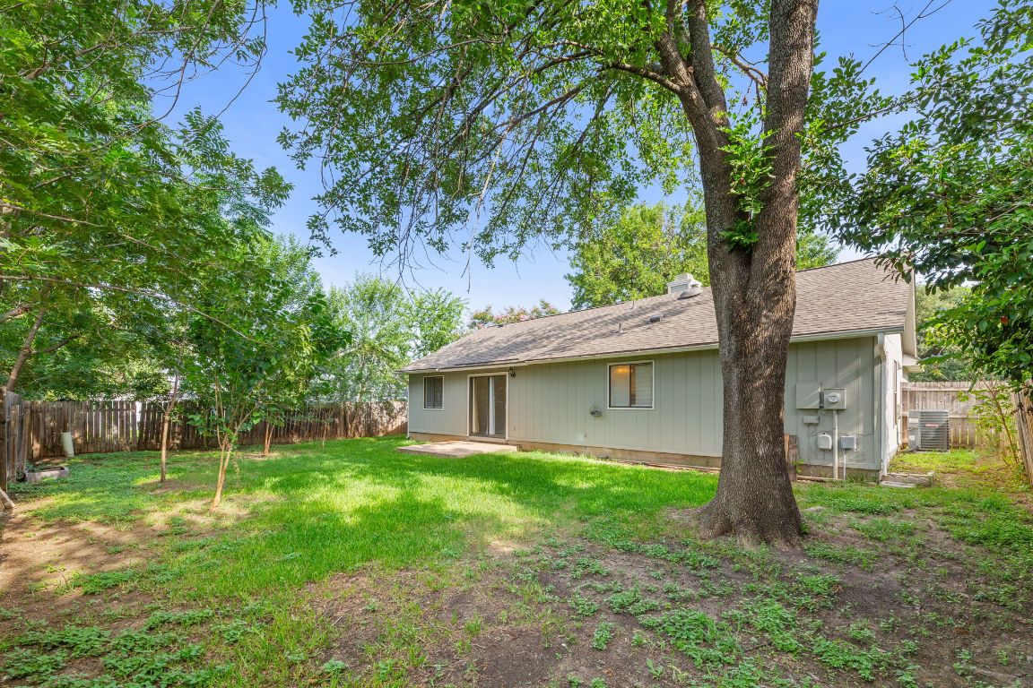 1808 Prairie Star Lane Round Rock, TX 78664 - Photo 29 of 32 a view of a house with a yard and a large tree