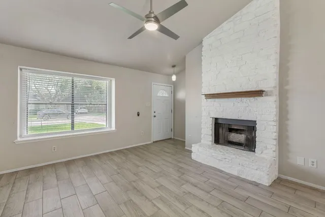 wooden floor fireplace and natural light in room
