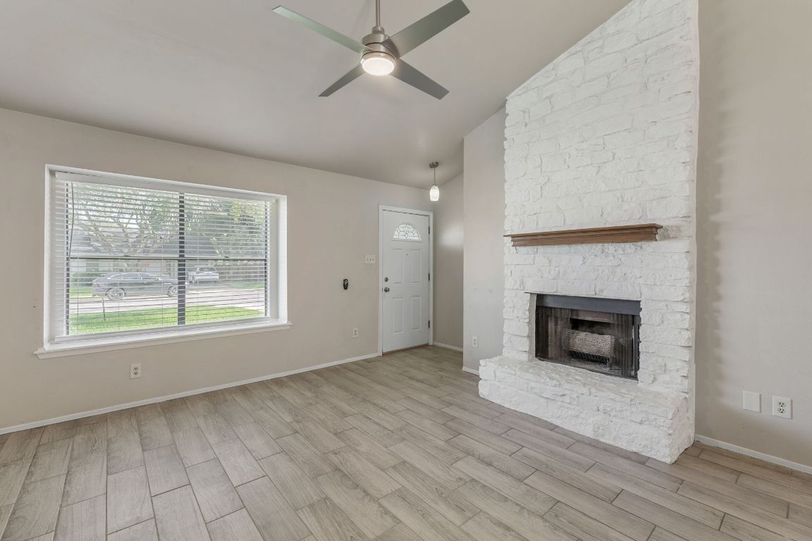 1808 Prairie Star Lane Round Rock, TX 78664 - Photo 6 of 32 wooden floor fireplace and natural light in room