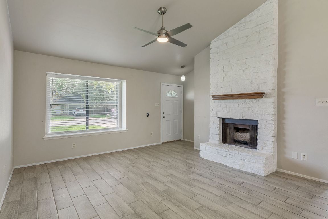1808 Prairie Star Lane Round Rock, TX 78664 - Photo 8 of 32 an empty room with windows and a fireplace