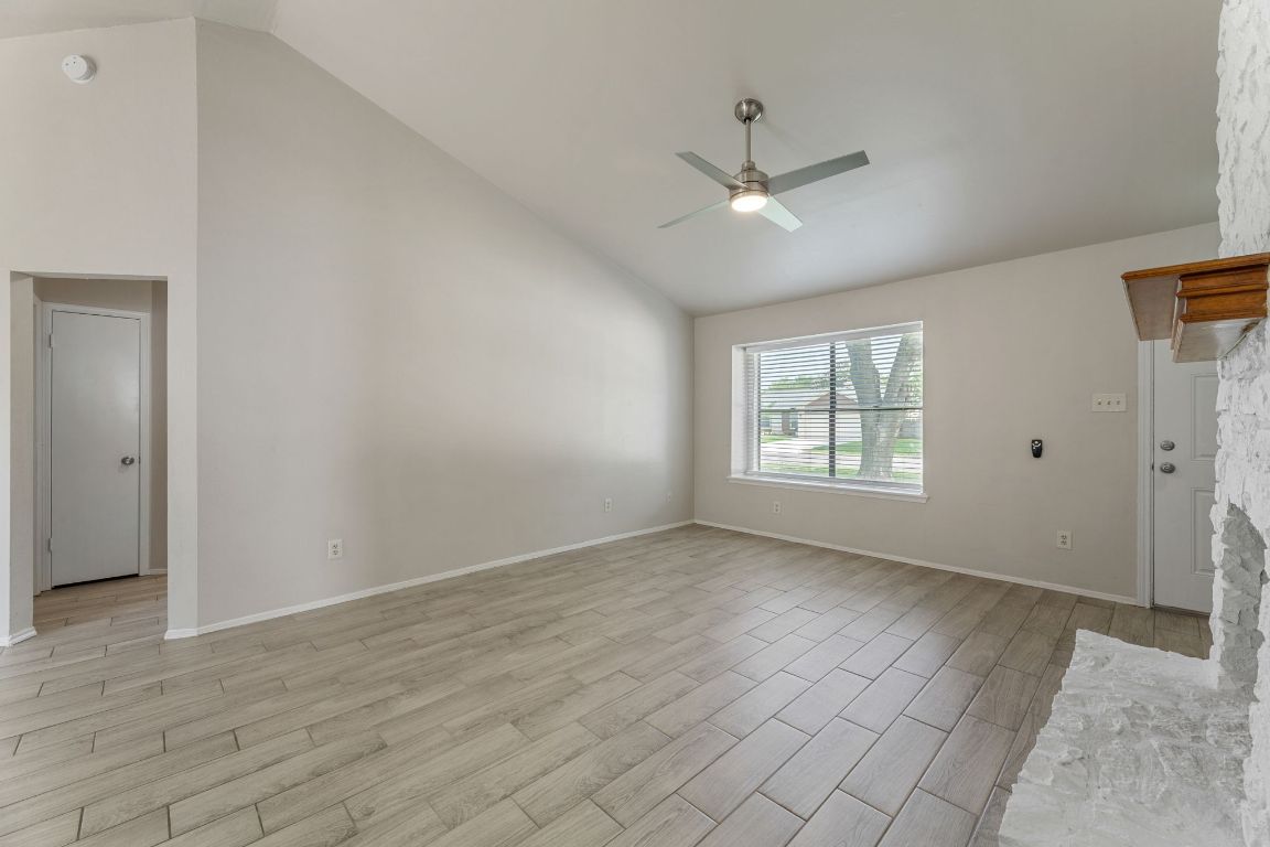 1808 Prairie Star Lane Round Rock, TX 78664 - Photo 9 of 32 wooden floor in an empty room with a window