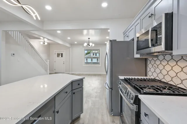 a kitchen with a stove and a refrigerator