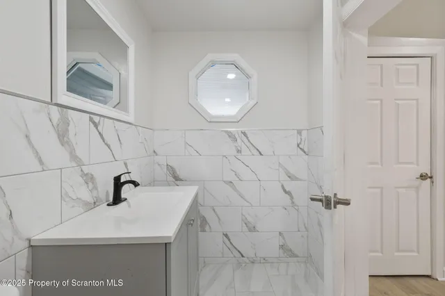 a bathroom with a sink and mirror