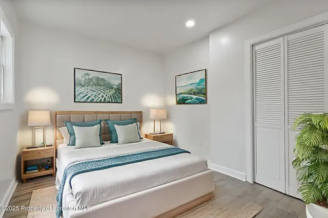 a bedroom with a bed and a painting on the wall