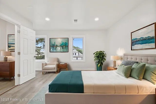 a bedroom with a large bed and a couch