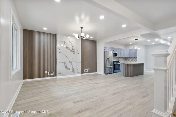 a view of a kitchen with a refrigerator and a sink