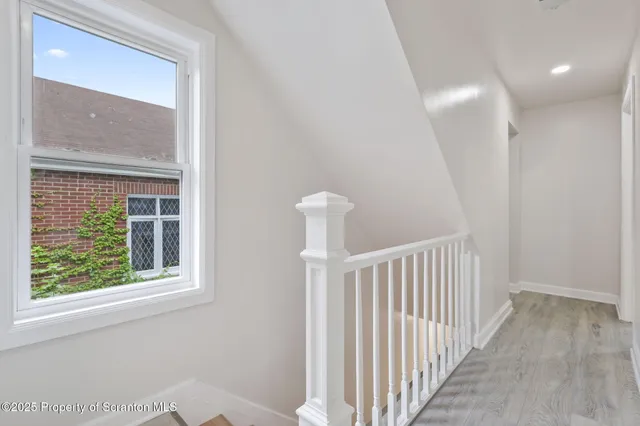 a view of a hallway with windows