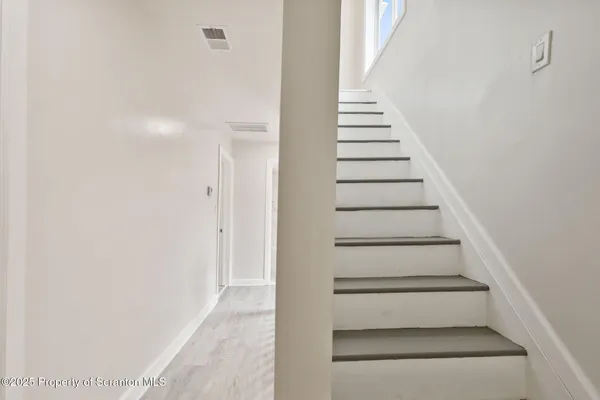 a view of staircase with white walls