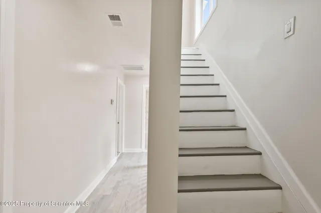 a view of staircase with white walls