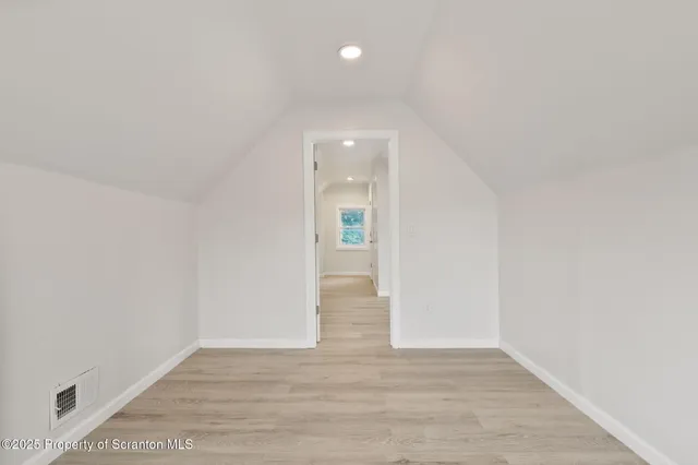 a view of an empty room and wooden floor