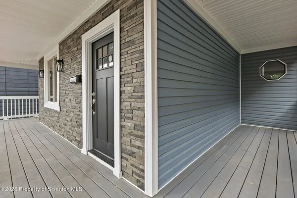 a view of a wooden door and brick walls