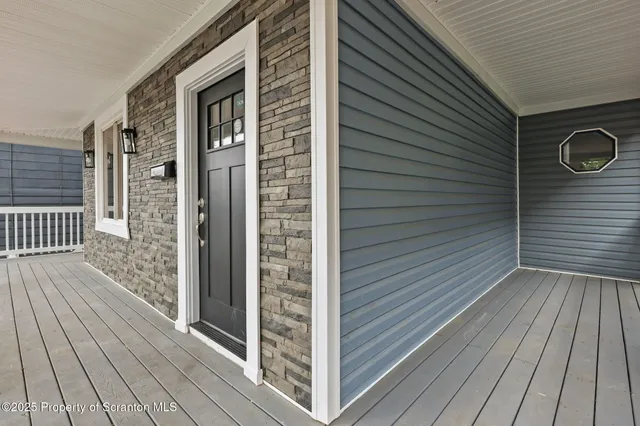 a view of a wooden door and brick walls