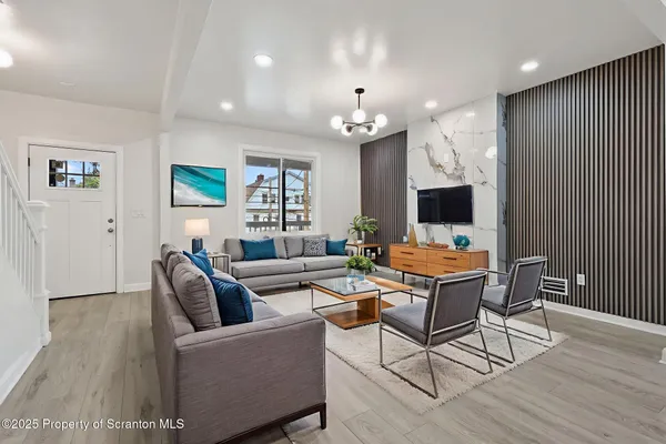 a living room with furniture and a flat screen tv